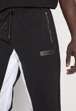 Pegador DEMERE WIDE TRACK PANTS UNISEX - Jogginghose - Black/white -Friboo Verkauf Geschaft c517c894d73f4e1cacc4579e5d655706